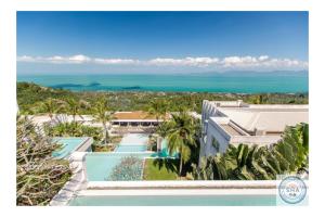 an aerial view of a resort with a swimming pool and the ocean at Panorama Samui Residences in Ban Bang Po