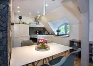 a kitchen with a table with flowers on it at Wohnperle Apartment Adele in Dresden