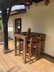 a wooden table and chairs on a wooden deck at La caseta Domaine du CANTEAU YF in Panjas