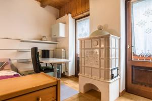 a room with a room with a table and a cabinet at Appartamento Albachiara 2 in Ossana +22 photos