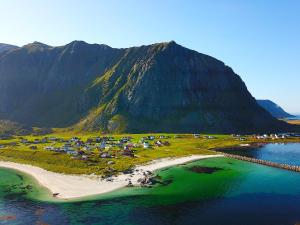 an aerial view of a beach with a mountain at Eggum Rorbuer in Bøstad