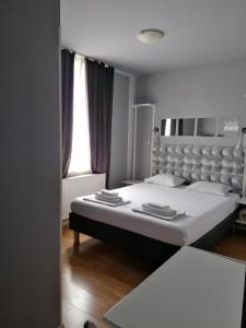 a bedroom with a large bed and a window at Studio Villa Antunovac in Zagreb