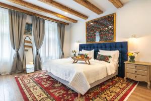 a bedroom with a large bed and a table at Nikolas Haus in Braşov