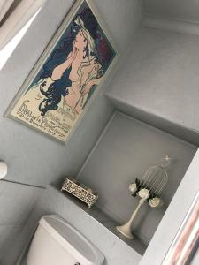 a bathroom with a painting on the wall and a toilet at The Exhibition in York