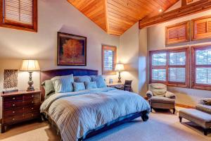 a bedroom with a large bed and a wooden ceiling at La Maconnerie #15 in Park City