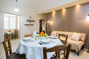 a dining room with a table and a couch at Joanna 's Loft in Kissamos