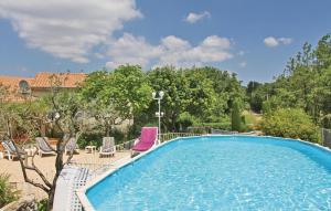 a swimming pool with two chairs and a purplevisorvisor at Pet Friendly Home In Puy Saint Martin in Puy-Saint-Martin