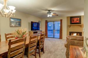 a dining room with a table and a tv at 1475 Park Avenue - Unit #6 in Park City