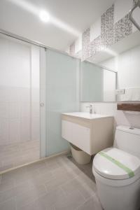 bagno bianco con servizi igienici e lavandino di 日軸蒔光 a Città di Hualien
