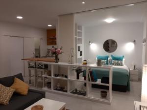 sala de estar con cama y cocina en Living4Malaga Loft San Francisco, en Málaga