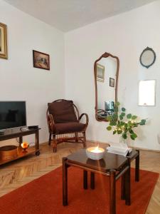 a living room with a table and a mirror at Sunshine house in Pančevo
