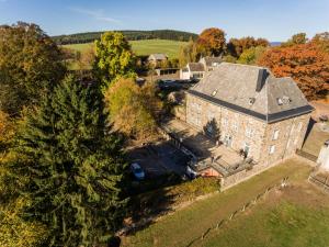 an aerial view of a large stone house with a yard at Gîte-Auberge Kaleo de Wanne in Trois-Ponts