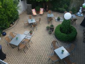 
a patio area with tables, chairs, and umbrellas at Hotel Schlömer in Cloppenburg
