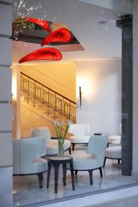a dining room with red umbrellas in the window at The Excelsior - Small Luxury Hotels of the World in Thessaloniki