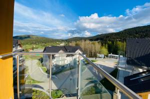 a balcony with a view of a house at Apartamenty Czarna Góra Veraneo in Sienna +13 photos