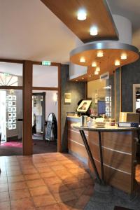 a bar in a restaurant with a counter at Hotel Schlömer in Cloppenburg