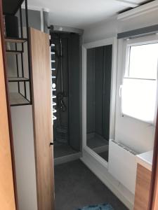 a bathroom with a shower and a glass door at RBR 1211 - Beach Resort Kamperland in Kamperland