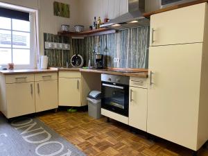 a kitchen with white cabinets and a stove top oven at Roggendorf 2, zentrumnah und voll ausgestattet in Mechernich