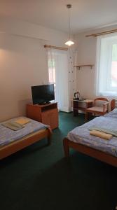 Llit o llits en una habitació de Penzion pod Vlkolíncom