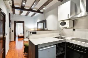 a kitchen with a sink and a microwave at Stay U-nique Apartments Obradors in Barcelona