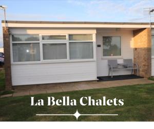 a house with a bench in front of it at LA BELLA CHALETS 1 - 154 Sunbeach Holiday Village Scratby in Scratby