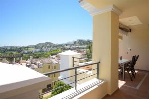 a balcony with a view of a city at Los Arqueros Las Jacarandas in Benahavís