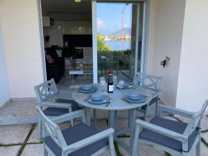 a table with two chairs and a bottle of wine at Amadeus in Baveno