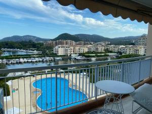 a balcony with a view of a river and buildings at JACARANDA II Appartement in Mandelieu-La Napoule