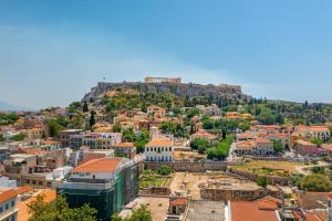 an overview of a city with a hill in the background at Hellenic Vibes Smart Hotel in Athens