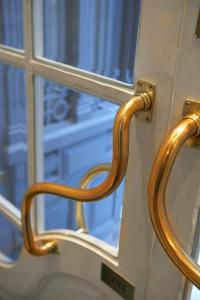 a wooden handle on a door with a window at The Excelsior - Small Luxury Hotels of the World in Thessaloniki