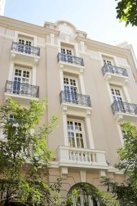 a large white building with balconies on it at The Excelsior - Small Luxury Hotels of the World in Thessaloniki