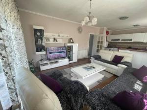 a living room with a couch and a table at Guest house Paradise Kolašin in Kolašin