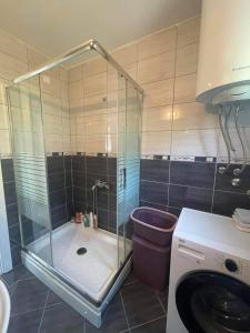 a shower with a glass door in a bathroom at Guest house Paradise Kolašin in Kolašin