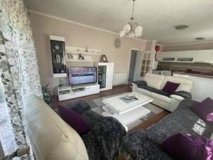a living room with a couch and a table at Guest house Paradise Kolašin in Kolašin