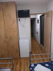 a room with a bed and a washer and dryer at Domek Kontenerowy N5 - 5 osobowy 2 Pokoje , Kuchnia , Łazienka - Izdebno- NoclegiGrodziskPL in Grodzisk Mazowiecki +1 photo