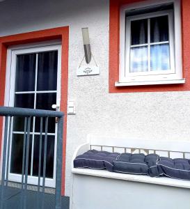 a building with two windows and a bench in front of it at Muemling Apartment 2 in Erbach