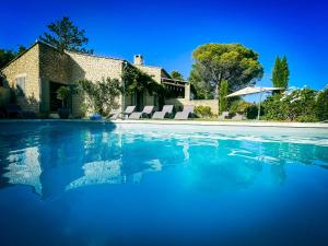 a swimming pool in front of a house at Mas La Bellevue in Murs