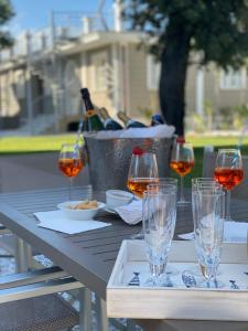 a picnic table with glasses of wine on it at Lido Luxury Villas in Lido di Camaiore +155 photos