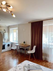 cocina y comedor con mesa y sillas en Apartment Sobornyi Prospect 95 en Zaporiyia