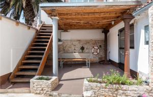 eine Terrasse mit einer hölzernen Pergola und einem Tisch in der Unterkunft Awesome Apartment In Liznjan With Wifi in Ližnjan