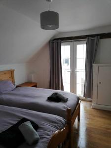 a bedroom with a bed and a large window at Nice big 2 double bedroom Apartment in the Town in Newquay