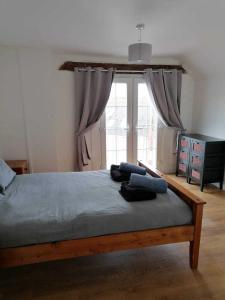 a bed in a bedroom with a large window at Nice big 2 double bedroom Apartment in the Town in Newquay