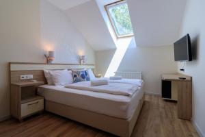 a bedroom with a large bed with a window at Villa Marina Inn in Siófok
