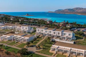 an aerial view of a house with the ocean at Capo Falcone Charming Apartments in Stintino