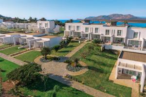 an aerial view of a house with a yard at Capo Falcone Charming Apartments in Stintino