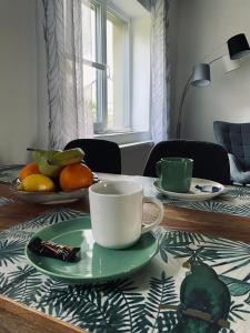 a table with a cup and a plate on it at Haus Lavendel in Vinningen