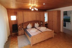 a bedroom with a large bed with wooden walls at HAPPY PLACE Pusteblume in Halblech