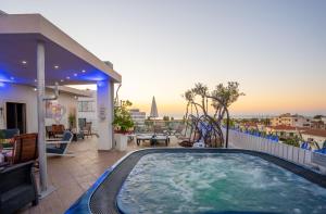 a hot tub on the balcony of a house at Mesogios House Suites in Larnaca