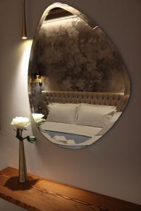uno specchio appeso a una parete con un letto di Honeymoon Venice a Venezia