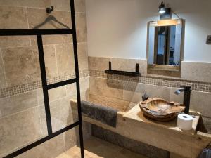 a bathroom with a sink and a mirror at La Grange in Avallon